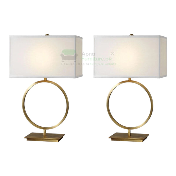 Two table lamps with gold circular bases and white lampshades on a white background.
