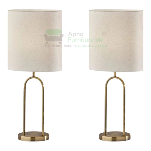 Two table lamps with beige lampshades and brass bases on a white background.