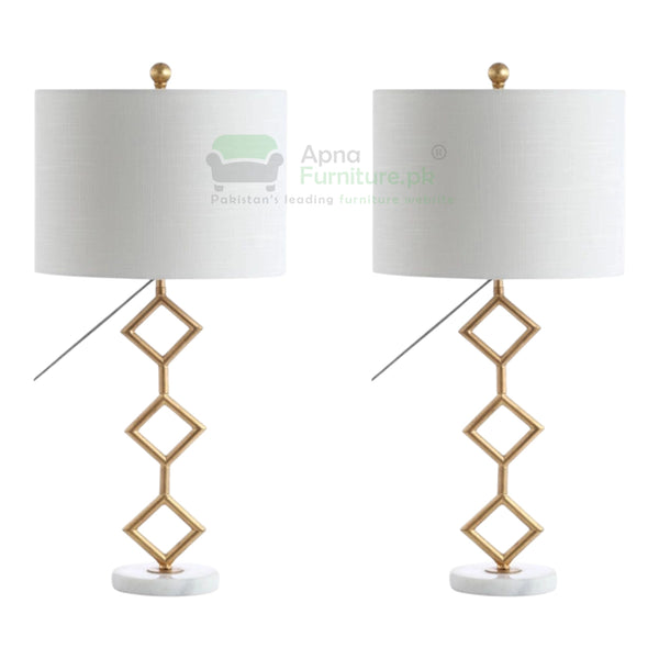 Two table lamps with gold geometric design and white lampshades on a white background.