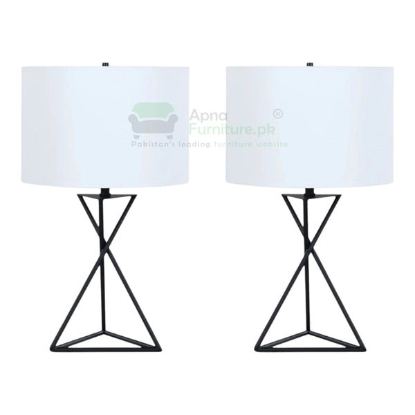 Two table lamps with white lampshades and black geometric bases on a white background.