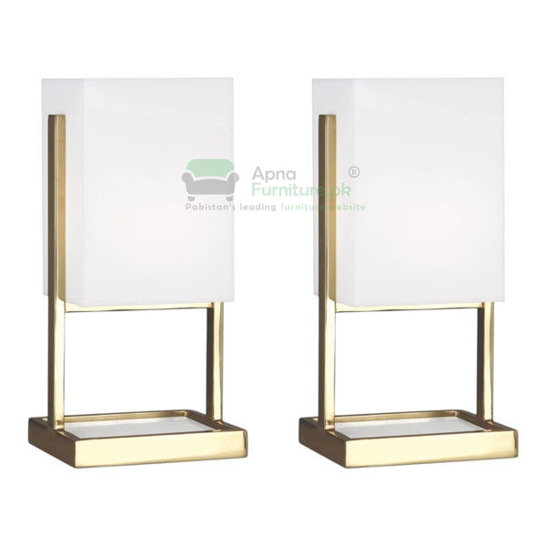 Two table lamps with white shades and gold bases on a white background, branded 'Apna Furniture 