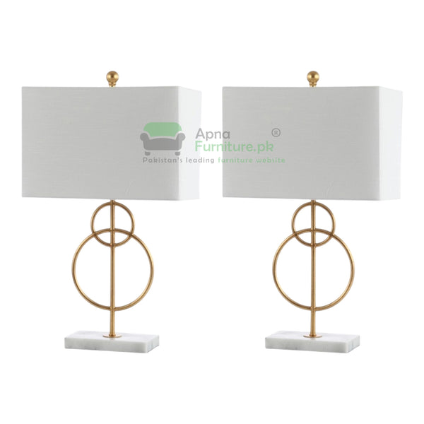 Two gold table lamps with white lampshades on a white background, branded 'Apna Furniture'.