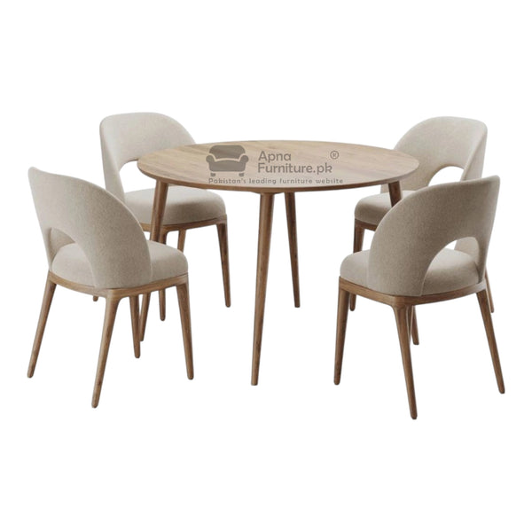 Round wooden table with four matching chairs on 