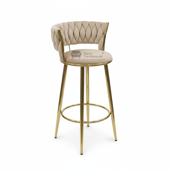 Bar stool with gold legs and beige cushioned seat on a white background
