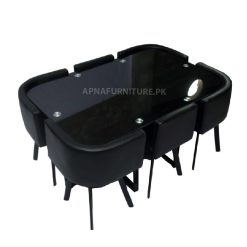 black dining table for six persons in glass top and foam padding chairs